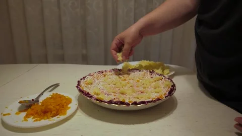 Right hand sprinkling grated boiled potatoes over salad Stock Footage 342362255