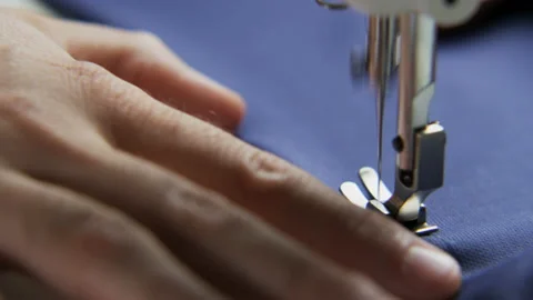 Right Hand of a Tailor Using a Sewing Machine Stock Footage 89576540