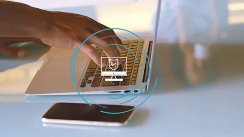 Right hand typing laptop keys causing shield icon and pulsing rings centered Stock Footage 334810860