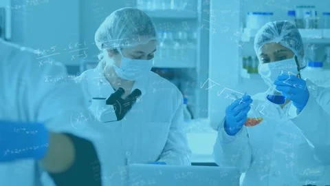Right lab tech raising orange blue vials, team comparing color and logging, math Stock Footage 330444176