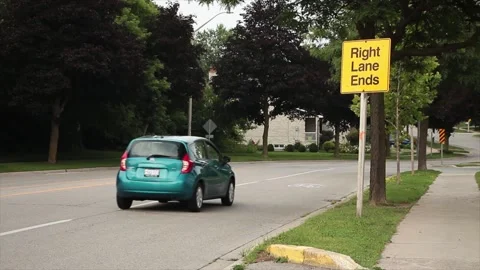 Right lane ends square sign in capital black letters on yellow background Stock Footage 246611585