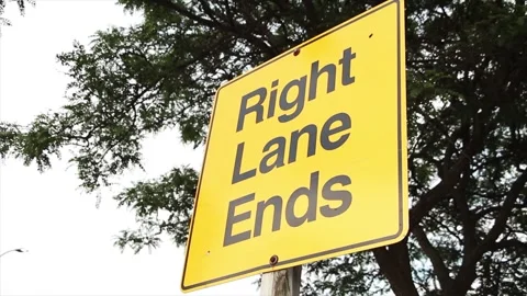 Right lane ends square sign in capital black letters on yellow background Stock-Footage 246611593