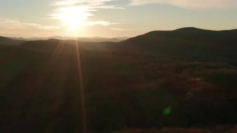 Right to left aerial track sunset over mountains. Video stock 229669208