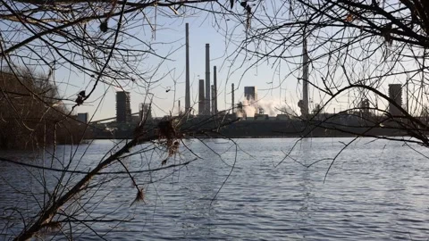 Right to left pan across river to sunrise industry Stock Footage 331201302