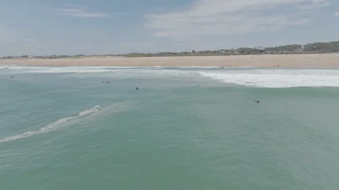 Right to left pan beach with surfers Video stock 345249503