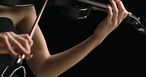 Right to left pan on black electrick violin played by blonde violinist Stock Footage 274864710