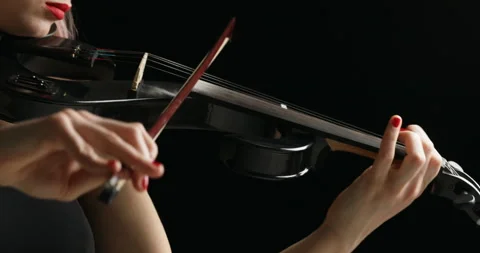 Right to left pan on black electrick violin played by blonde violinist Stock Footage 274865126