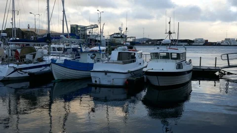 Right to left pan boats docking in a small town pier Stock Footage 92641234