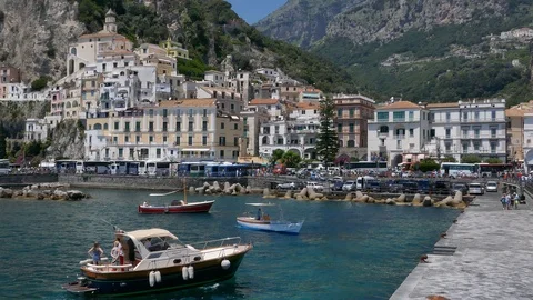 Right to left pan establishing shot of the city of Amalfi in Italy from the port Stock Footage 113244478