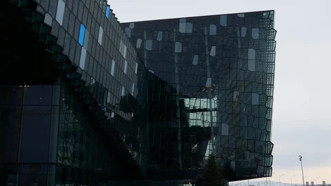 Right to left pan in exterior view of Harpa concert hall and conference centre Video stock 93219310