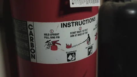 Right to left pan onto a fire extinguisher - safety instructions Stock Footage 89502062