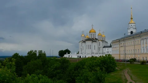 Right to left pan from forest to holy assumption cathedral in Vladimir, Russia Stock Footage 98380785