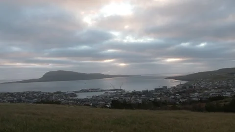 Right to left pan small town of Torshavn near sea mountainous island background Stock Footage 92642462