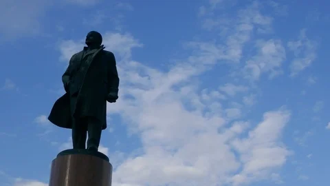 Right to left pan on the symbol of Communism the Lenin Monument with blue sky Stock Footage 99607298