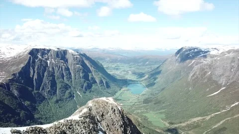 Right to left side drone shot of mountain peak in Norway Stock Footage 157697062