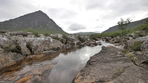 Right to Left Slow Shot of Granite Rocks and Scottish Landscape with a River 動画素材 97361957
