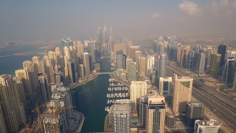 Right to left tracking drone shot flying above Dubai Marina Stock Footage 105702805