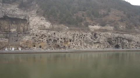 Right to left view of Longmen grottes with the Giant Buddha in center of it Stock Footage 125338646