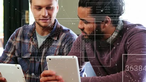 Right man bringing tablet closer at wooden table, colleagues working on data Stock Footage 333193461