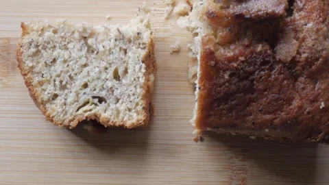 Right pan of banana bread cut in half on a wooden board 스톡 동영상 296574708