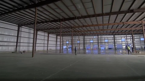 Right Pan of Construction Workers Working on Floor in New Building Stock-Footage 101390460