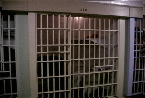 Right pan from corridor over prison inmates in cells Stock Footage 86919955