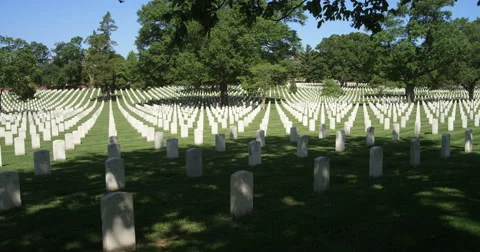 Right pan over rows of government-issued grave markers in Arlington National Stock Footage 59263783