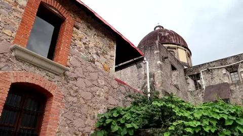 Right pan of stone facade with windows and church dome 動画素材 290034012