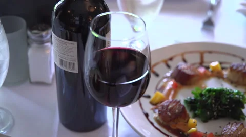 Right pan from wine to a fancy dinner Stock Footage 67387980