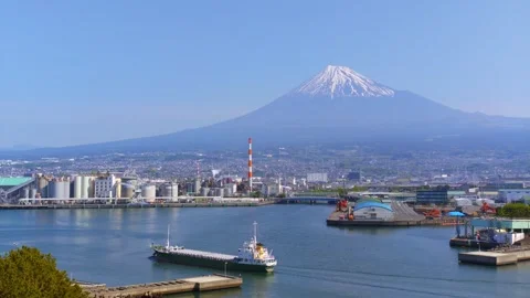Right panning shot of Mt. Fuji and Tagonoura Port with Ship Stock Footage 334679871