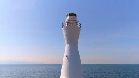 Right panning shot of a white lighthouse and Pacific Ocean Stock Footage 334679876