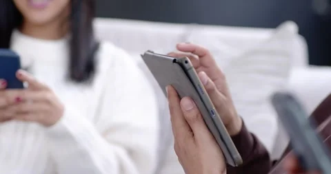 Right person is lifting tablet, tapping, swiping and switching to phone, Stock-Footage 345607871