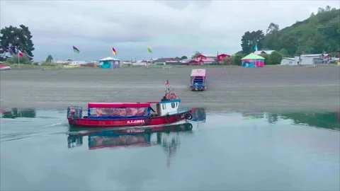 Right profile close-up of red boat with hill and beach 動画素材 340994444