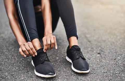 The right shoes make all the difference. Closeup shot of a sporty woman tying Stock Photos