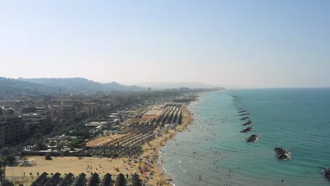 Right Side Aerial Pan Of Ocean With Rock Formation Off Of Pescara Coast Видео 120039558