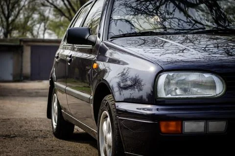 Right side of a dark blue passenger car with reflections. Stock Photos