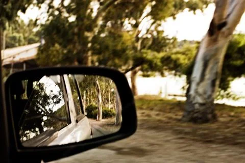 Right side mirror in the car among the trees Stock Photos
