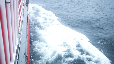 Right side of ship sailing into stormy sea. Cloudy day. Ship leaving dock Stock Footage 89545802