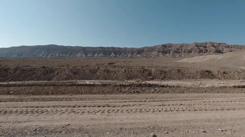 Right-side tracking view of barren desert mountains and dry rocky ground Stock Footage 319794828