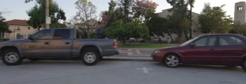 Right Side view of a Driving Plate: Car makes a loop on the forecourt of City Stock Footage 59334360