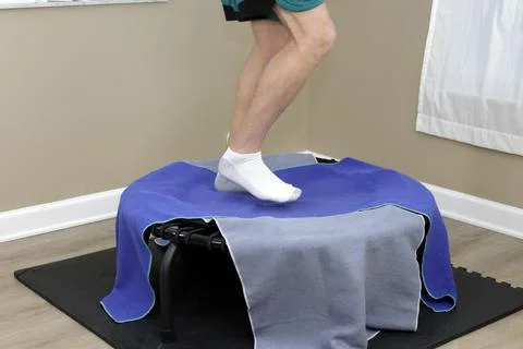 Right Side View of Lower Legs of a Male Rebounding on a Rebounder. Stock Photos