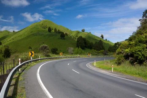 Right Turn. Empty winding roadway in countryside Stock Photos