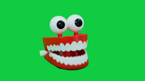 Right view of novelty teeth chattering away against a greenscreen. Stock Footage 141336878
