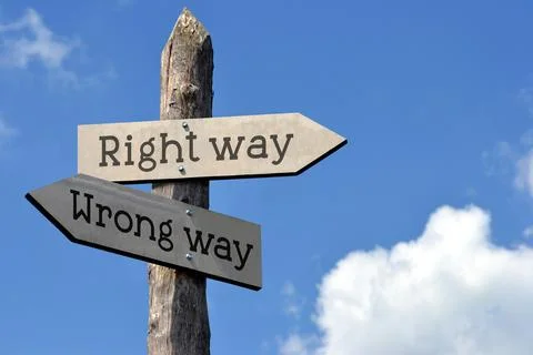 Right way or wrong way - wooden signpost with two arrows, sky with clouds Stock Photos