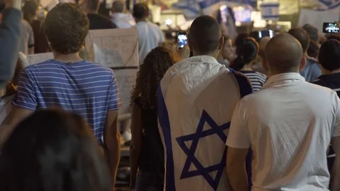 Right wing protest, person wrapped in Israeli flags, Rabin Square, Tel Aviv Stock Footage 70727267
