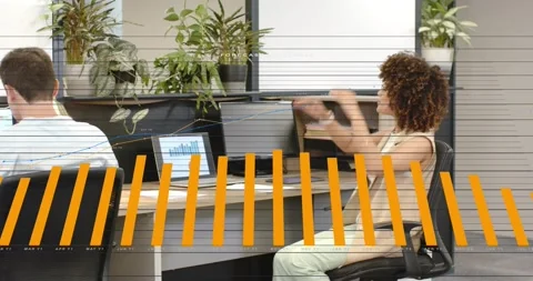 Right woman pausing typing, stretching before resuming laptop chart work, biz Stock Footage 332274494