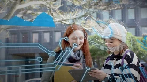 Right woman tapping tablet and activating AR HUD, two students sharing data and Stock Footage 333575309