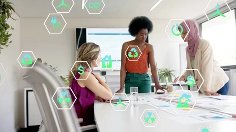 Right woman tapping tablet launching floating hex icons, team reviewing charts Stock Footage 335316908