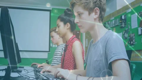Rightmost student typing at keys in computer lab initiating network overlay and Stock Footage 331235693