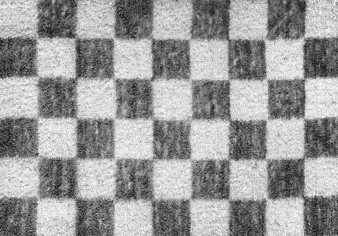 A rigid massage towel with a geometric pattern in the form of squares. 写真素材